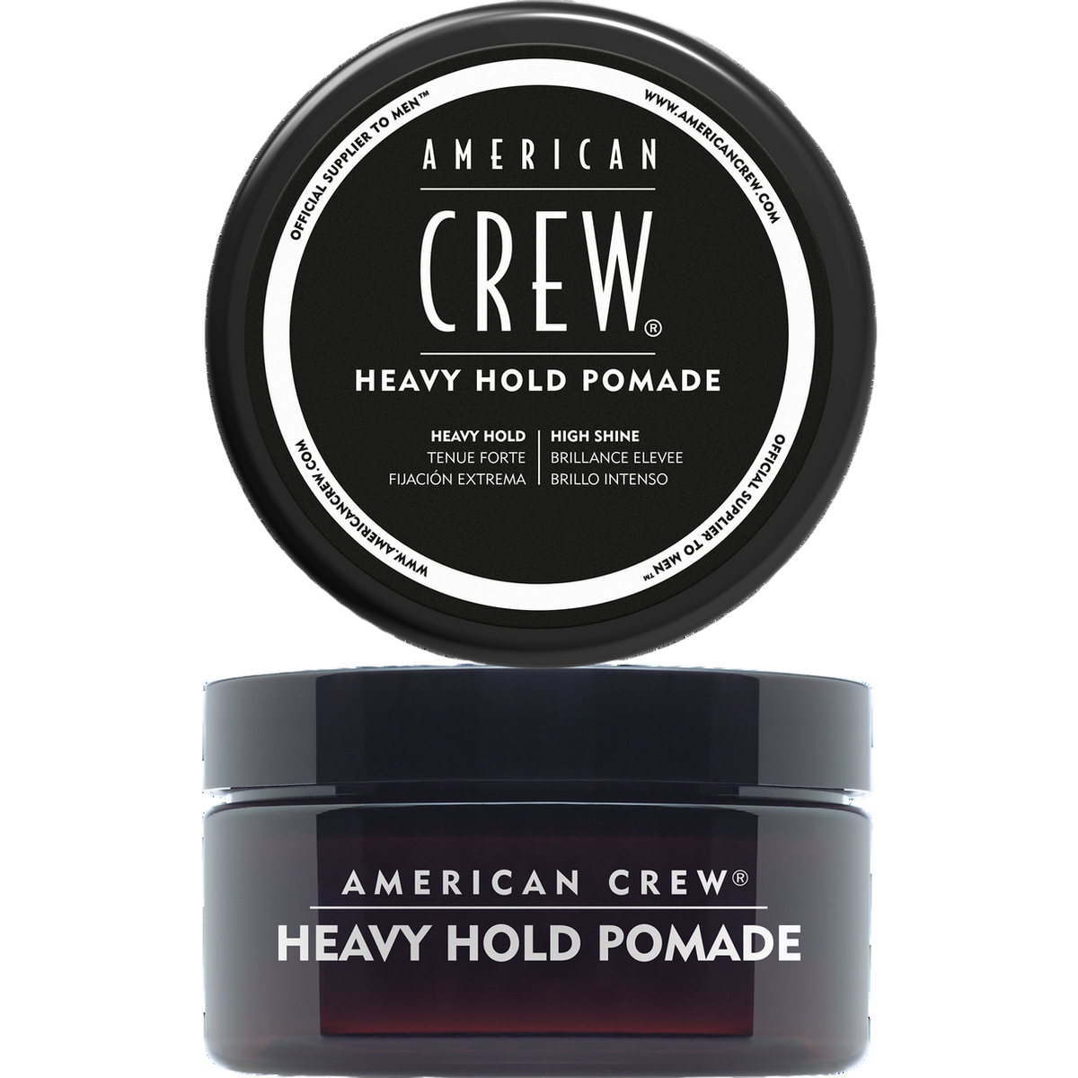 Translucent dark amber jar labeled American Crew Heavy Hold Pomade with its black lid removed and displayed above it, on a light grey backdrop.