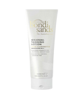 White squeeze tube labeled bondi sands The Australian tan, Gradual Tanning Lotion Skin Illuminator, with text noting shimmer pigments and a natural looking tan, 150ml, on a plain light gray background.