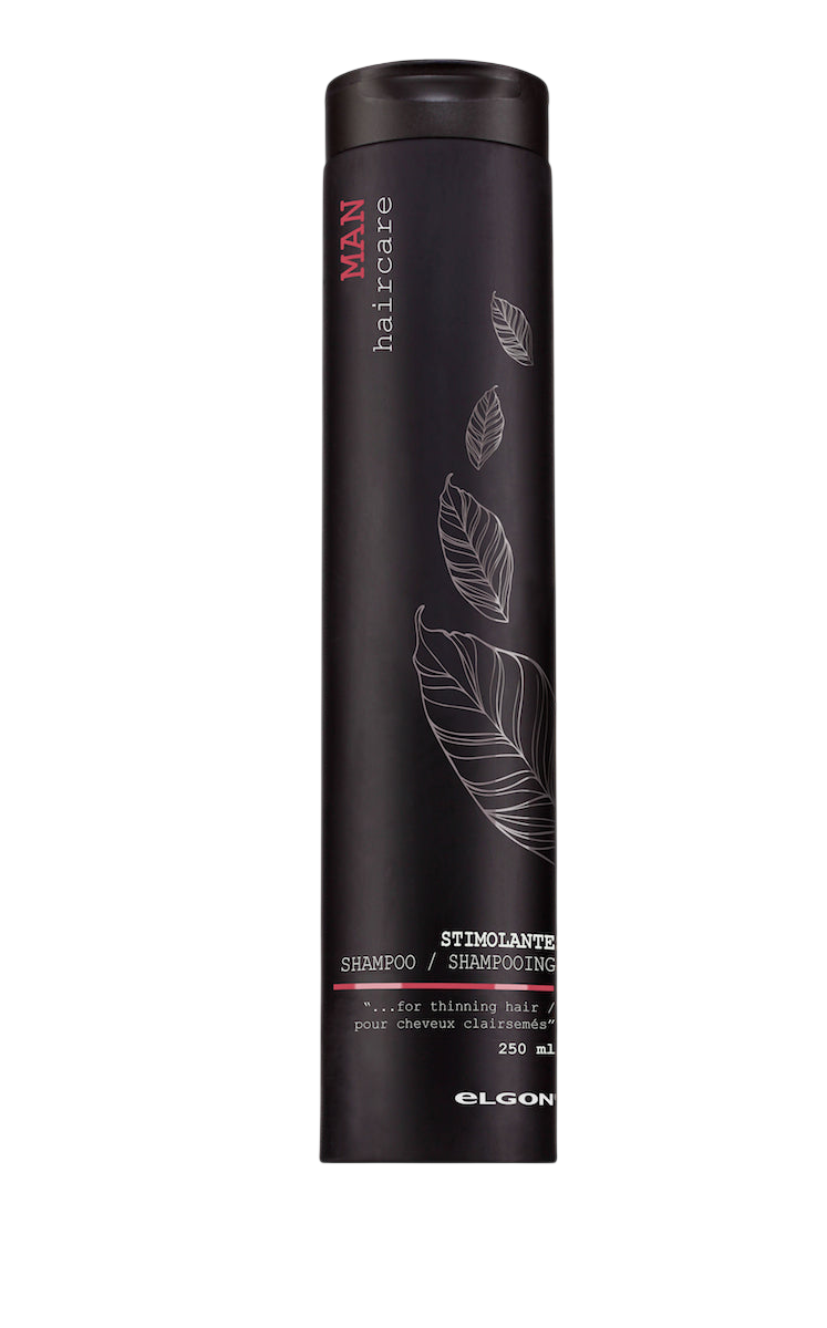 Tall black cylindrical bottle with a black cap and a line-drawn feather/leaf design, labeled Elgon Man Haircare Stimolante Shampoo, with text reading "for thinning hair," 250ml, on a light grey backdrop.