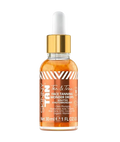 Clear glass dropper bottle with gold cap and white dropper, filled with bronze-tinted liquid, labeled Skinny Tan Tan & Tone Face Tanning Wonder Drops with a chevron-striped label listing Hyaluronic Acid, Organic Aloe Vera, Q10, Coconut Oil and Vitamin E, Net 30ml/1 FL OZ, on a plain light gray background.