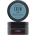 Translucent amber jar labeled American Crew Fiber with a black lid, light blue label text, lid displayed above the open jar, on a light grey backdrop.