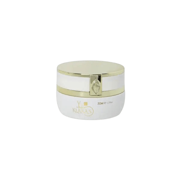 White cylindrical cosmetic jar with a glossy gold lid and gold trim band, labeled Klara's, 30ml, on a plain light gray background.