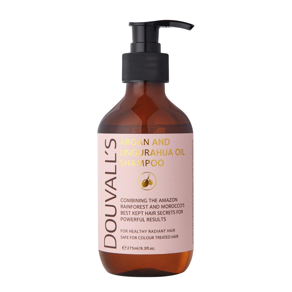 Amber pump bottle with a black pump top and a pink label reading Douvall's Argan and Ungurahua Oil Shampoo, 275ml, on a light grey backdrop.
