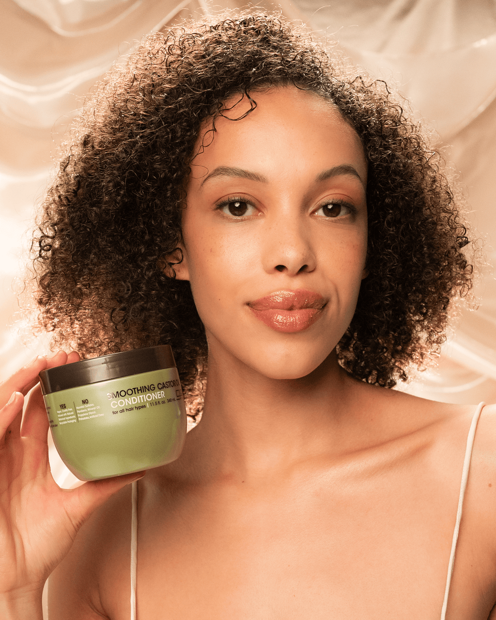 Lifestyle shot - using product in curly hair